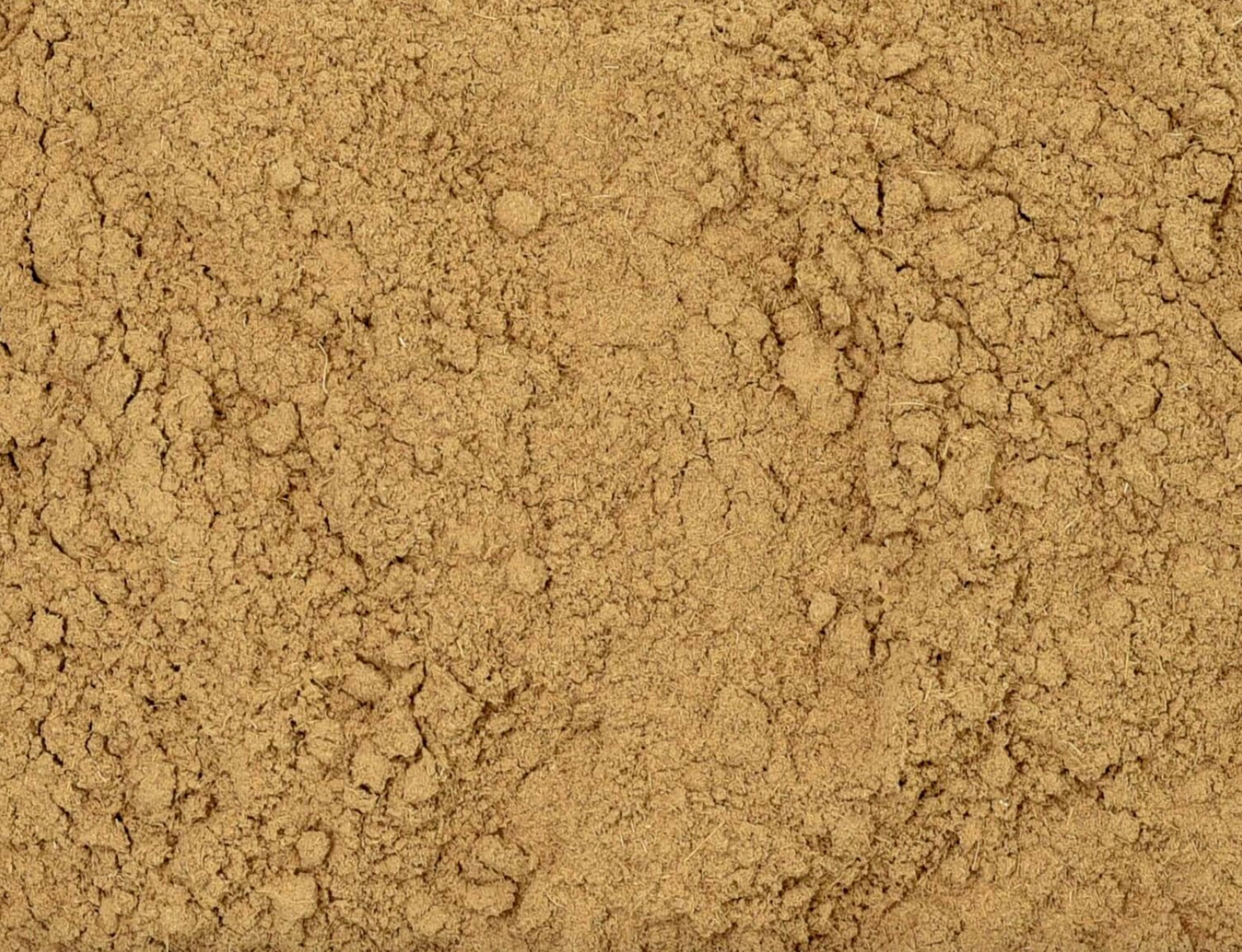 Close-up of dried licorice root powder, showing fine brown powder used for teas and herbal remedies.