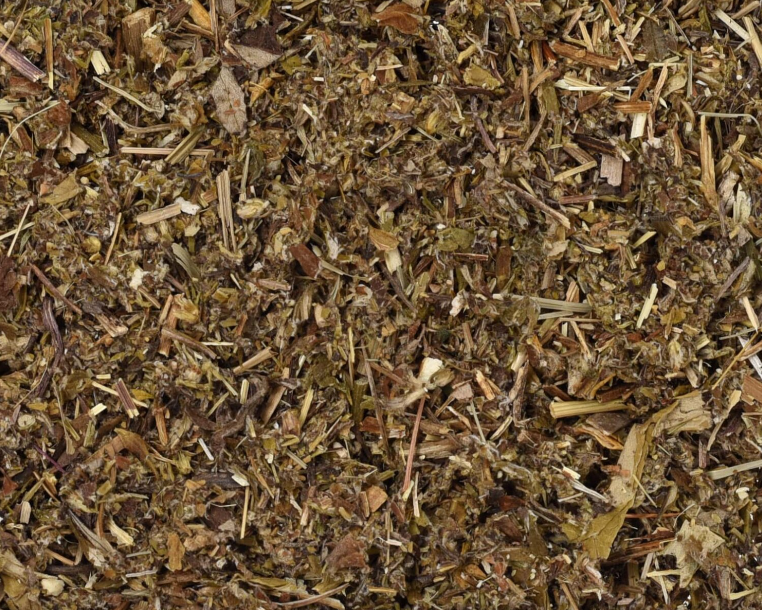 Close-up of dried mugwort herb, showing chopped stems, leaves, and pieces used for teas and herbal remedies.