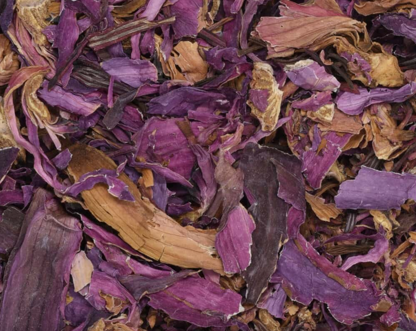 Close-up of dried red lotus petals, showing chopped red petal pieces used for teas and herbal remedies.