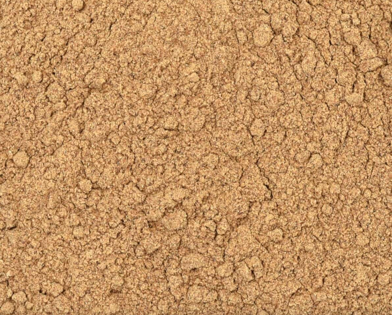Close-up of dried reishi mushroom powder, showing fine beige powder used for teas and herbal remedies.