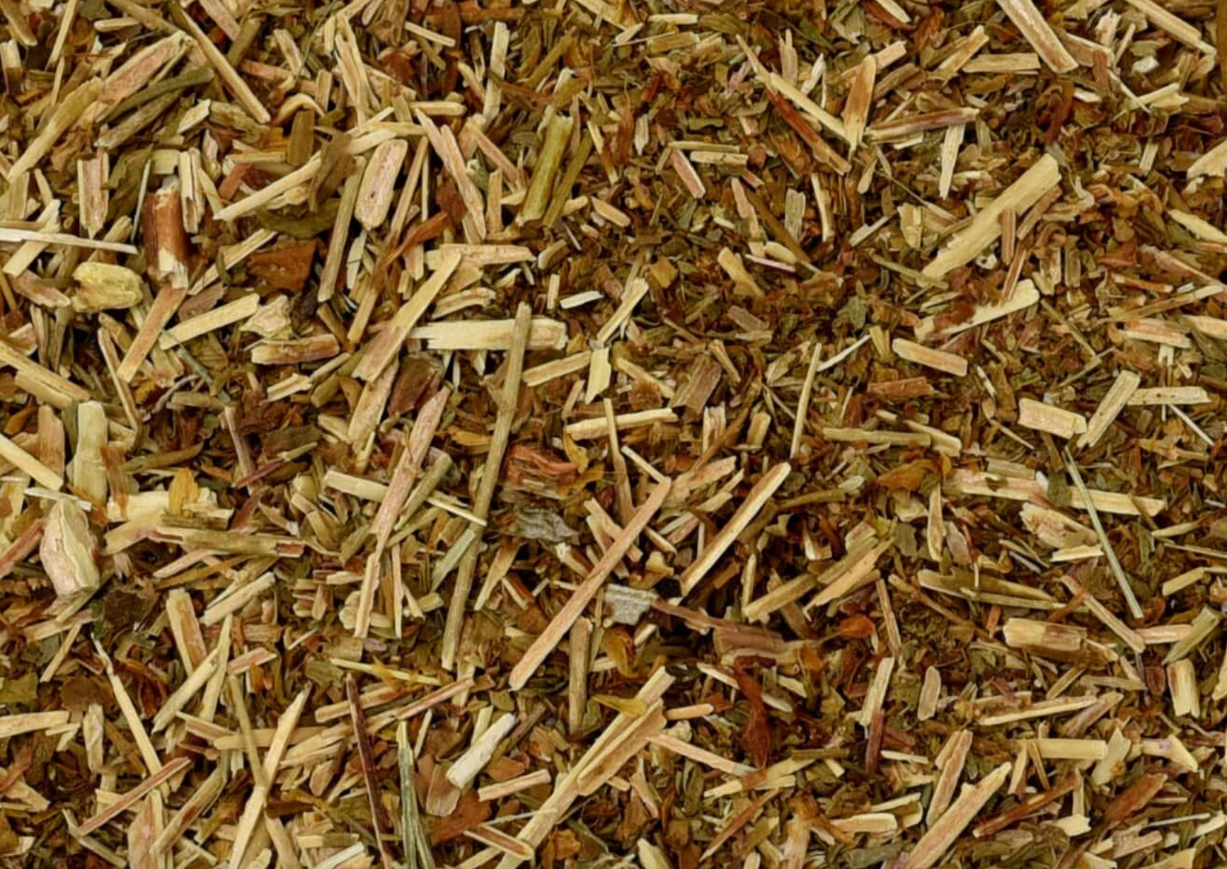 Close-up of dried St. John's wort herb, showing chopped stems, leaves, and pieces used for teas and herbal remedies.